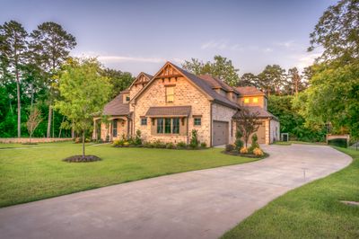 Stone home with manicured lawn